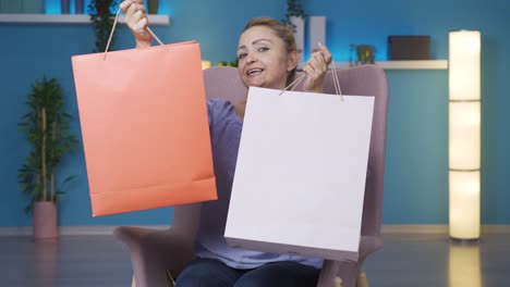 Woman-looking-at-camera-with-shopping-bags.